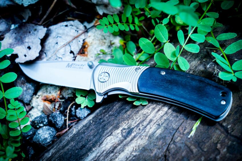 photography of knife near leaves